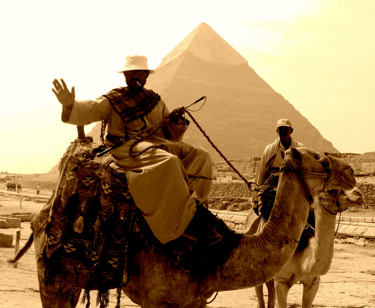 Tour guides on camels in front of Giza pyramids